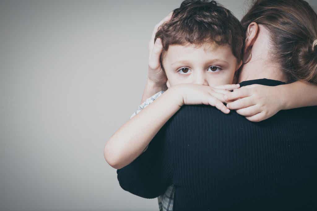 Boy with his mother hugging him