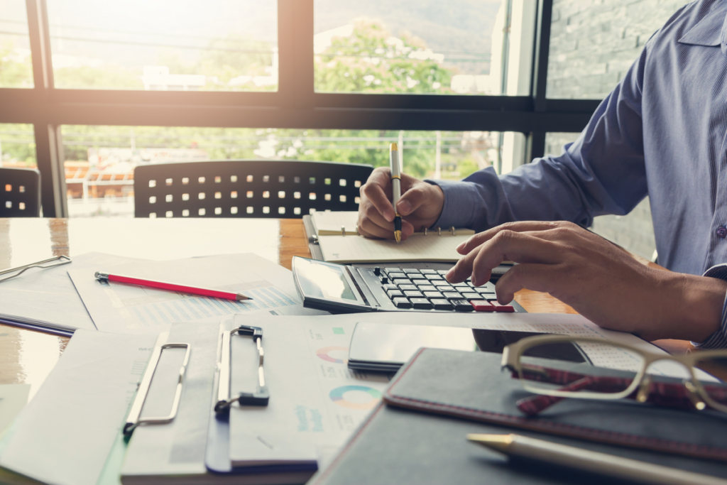 A man using a calculator to calculate statistics.