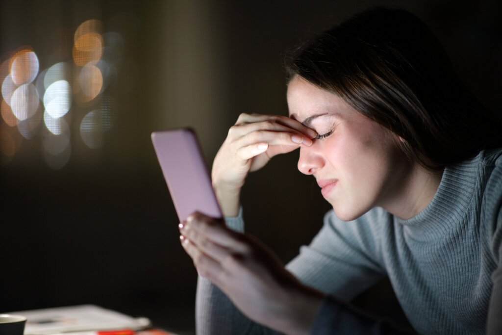 Woman on mobile, depicting when we investigate our partner's ex on the Internet.