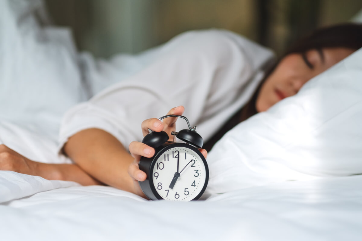 Woman turning off the clock