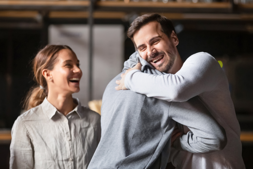 Friends congratulating each other to represent types of humility