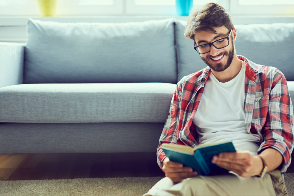 Young boy reading a self help book