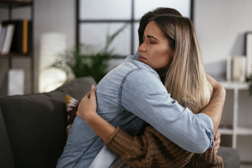 Un couple triste s'étreignant symbolisant que la personne endeuillée a besoin d'une intervention