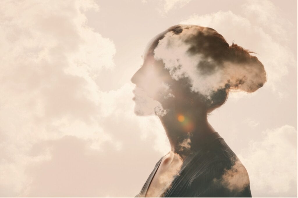 Woman with clouds to represent the defensive pessimist