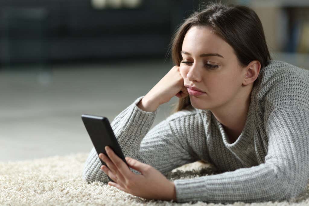Woman pouting mobile thinking controlling impulsive thinking