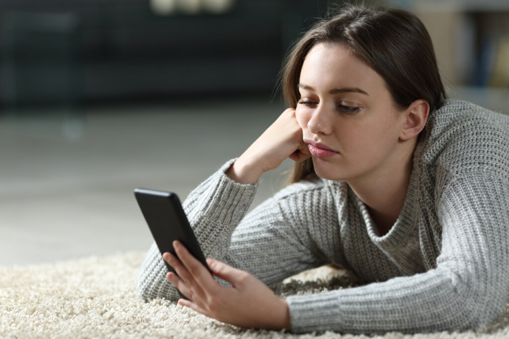 Vrouw met mobiel pruilend gezicht