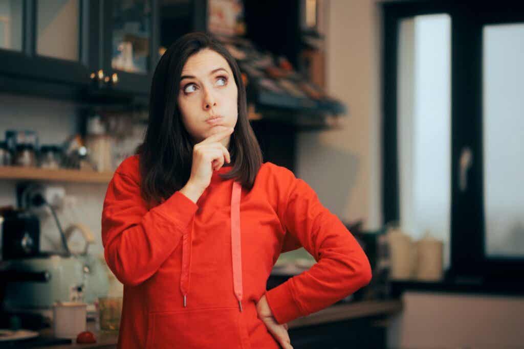 Pensive woman doesn't know what to buy for dinner