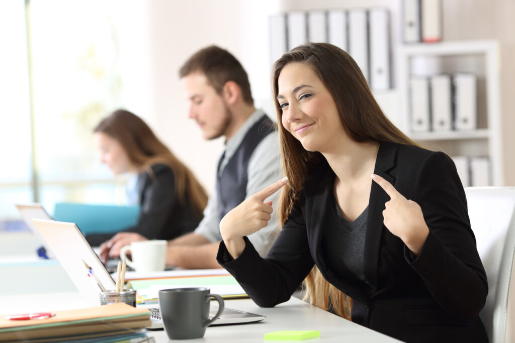 Female worker pointing to herself with a lot of ego symbolizing that experience is not always the best teacher