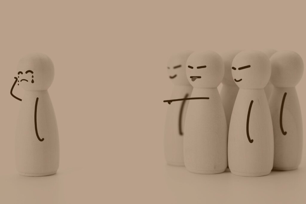 Harassment concept wooden figures harass a single