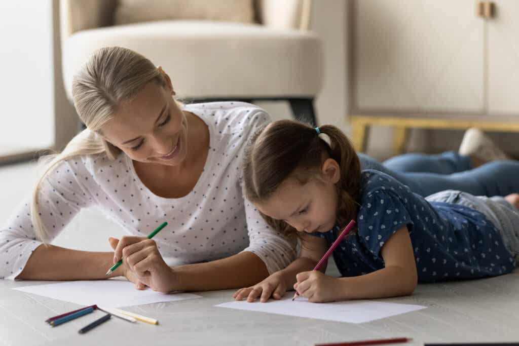 Mother drawing with her daughter thinking about when children when they are tired