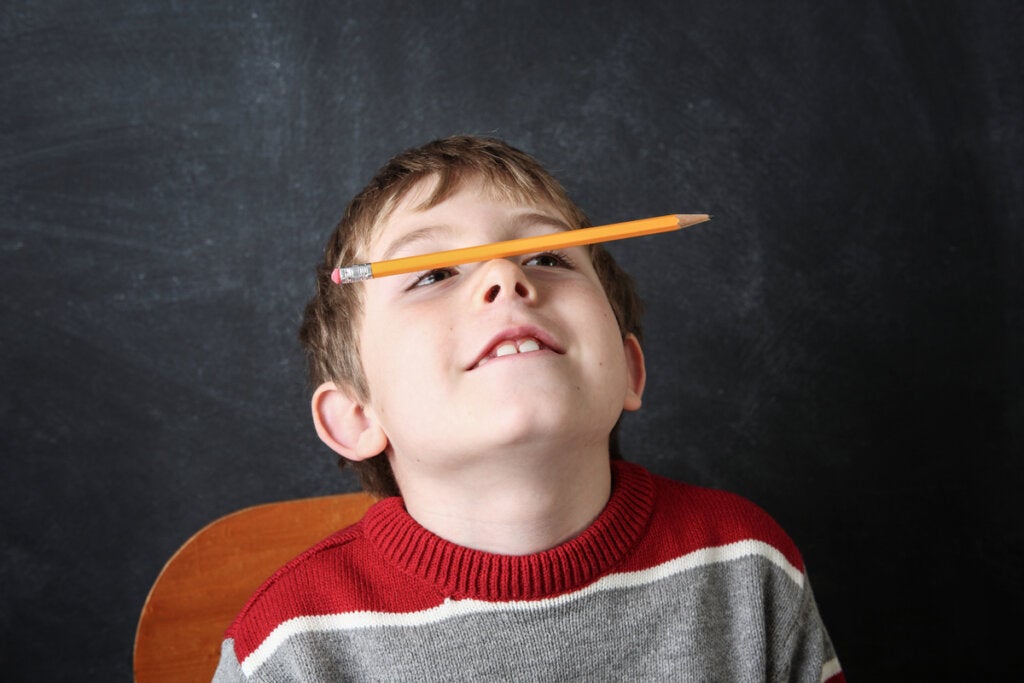 Boy with pencil on his nose
