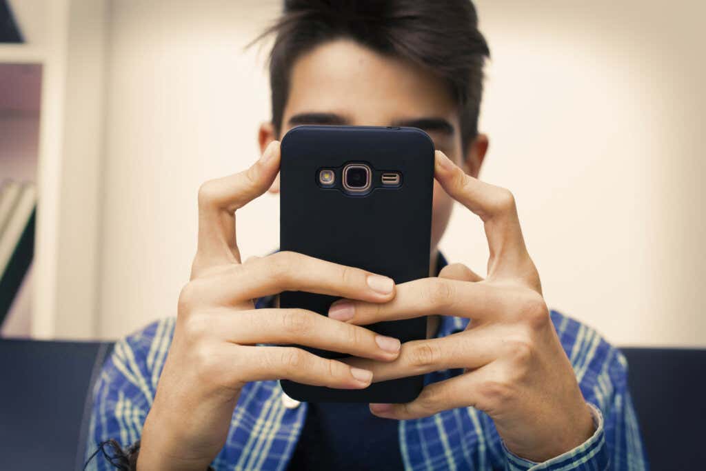 Teenager with mobile due to addiction to new technologies