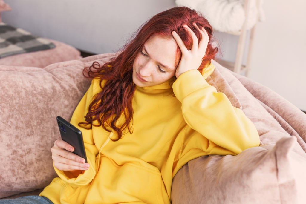 Sad teenager with mobile