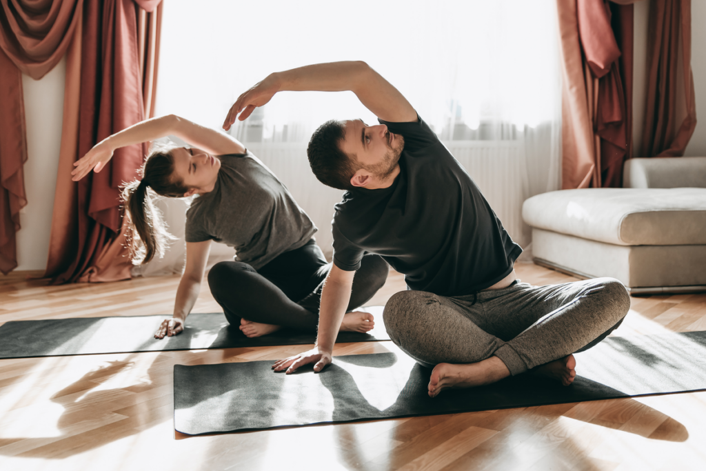 couple doing yoga, representing the importance of personal space in a relationship.