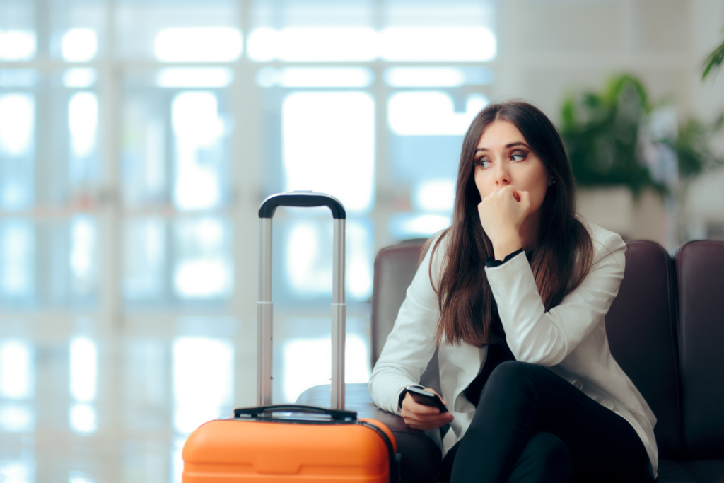 Worried woman with a suitcase, experiencing fears about emigration