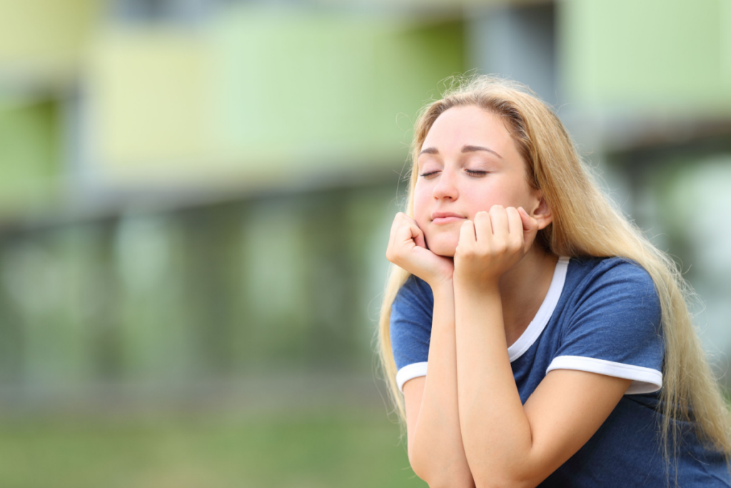 Teenager with eyes closed thinking about our first love