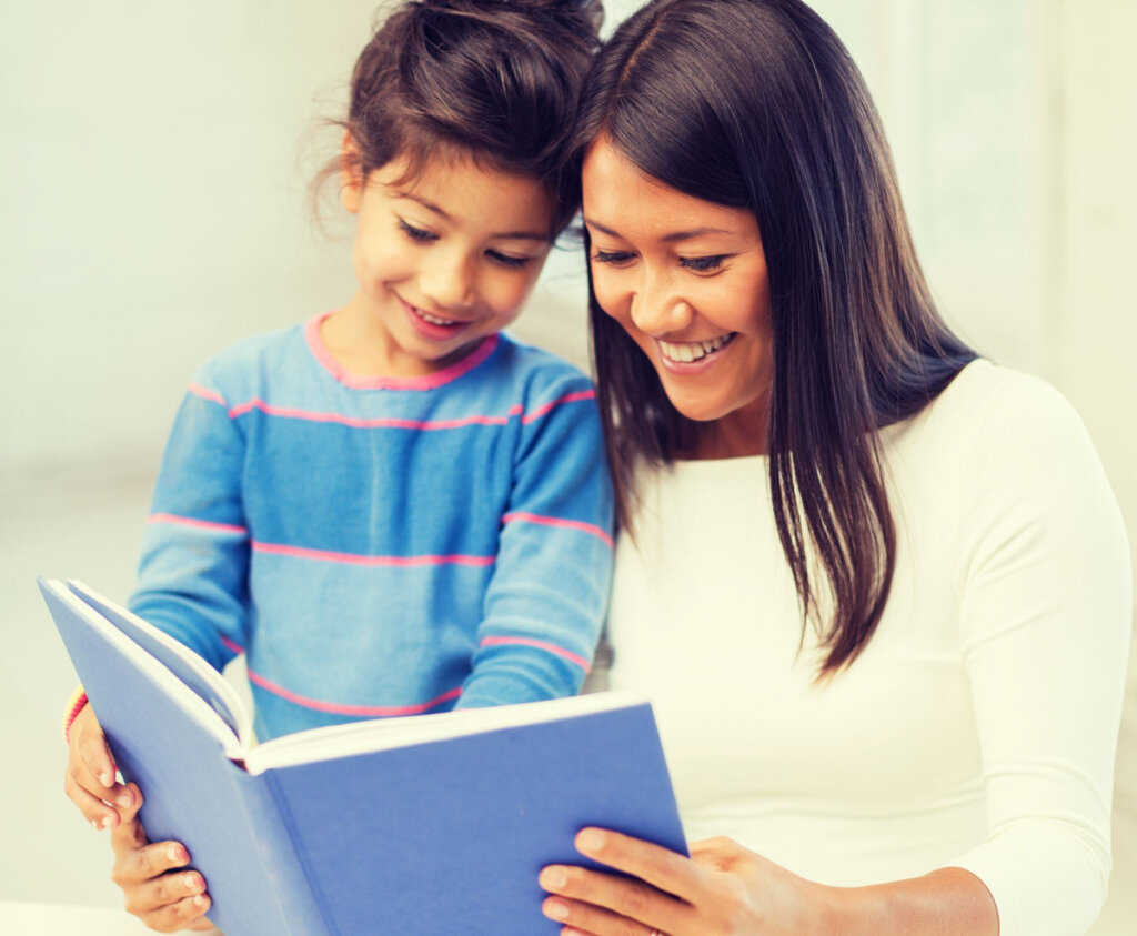 Woman reading book with girl