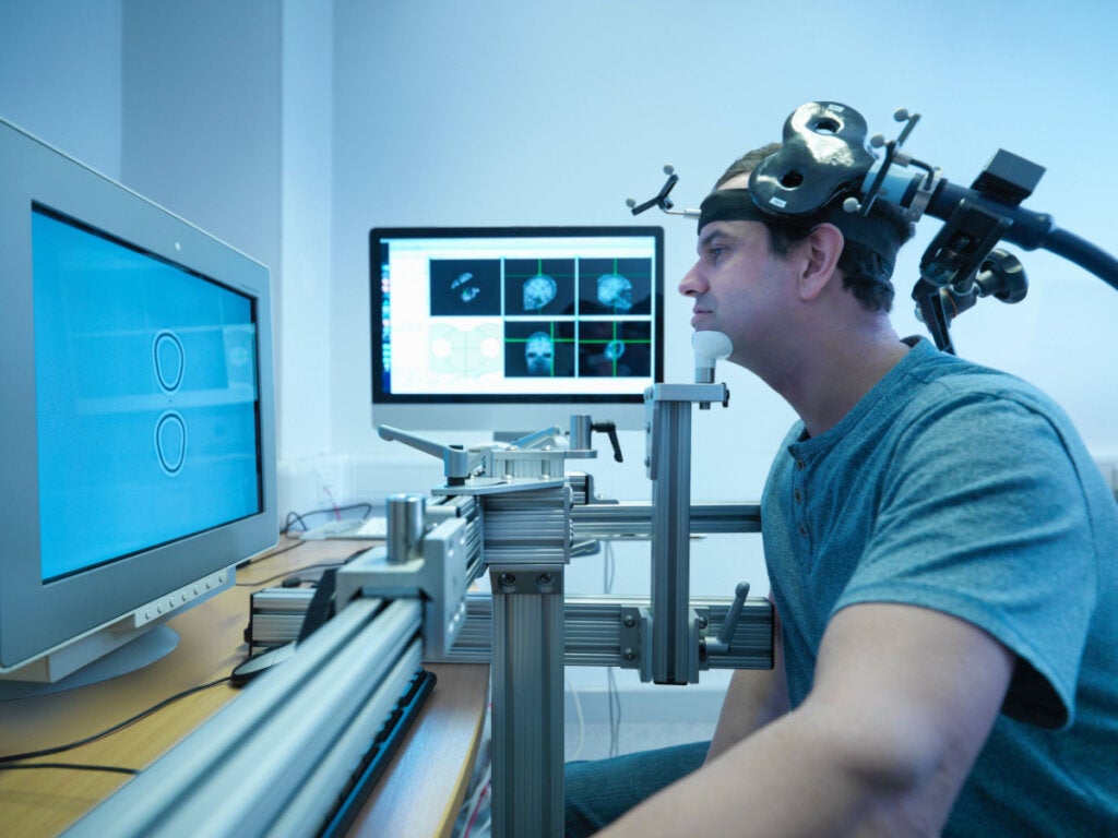 Man undergoing transcranial magnetic stimulation treatment