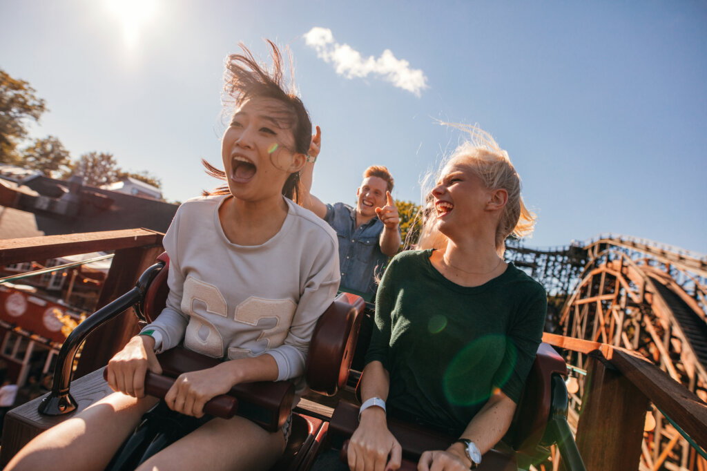 Girls on roller coaster enjoy the attraction