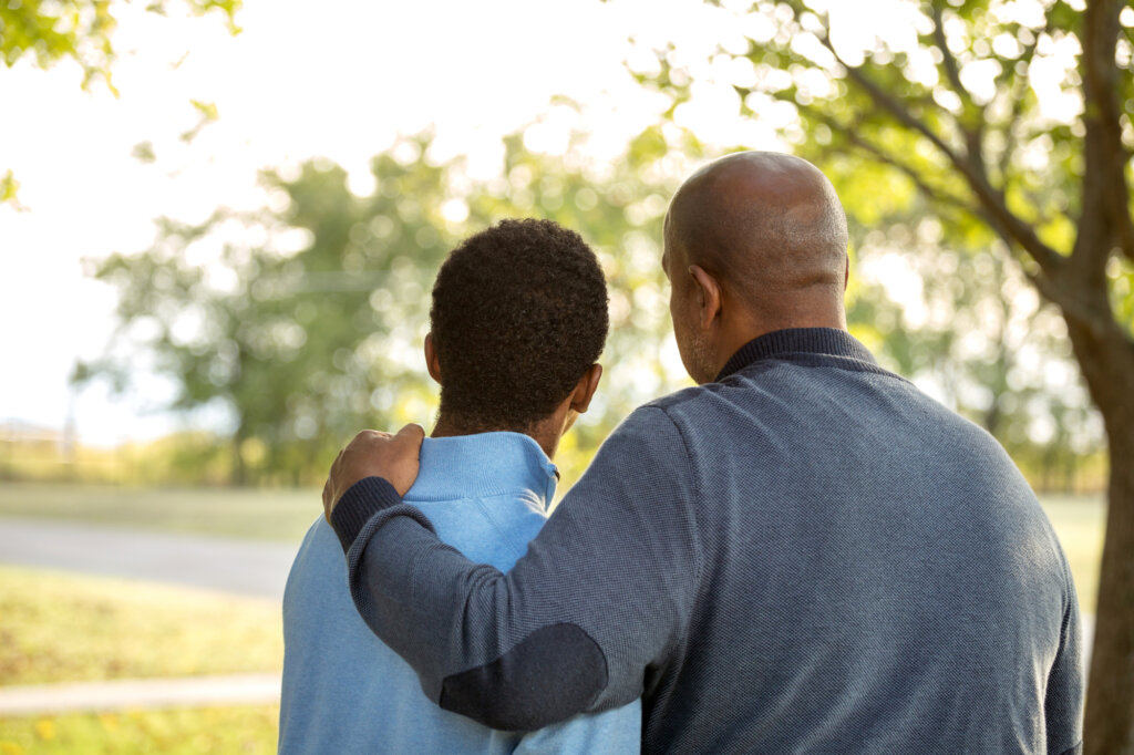 A father talking to his teen son about something serious.
