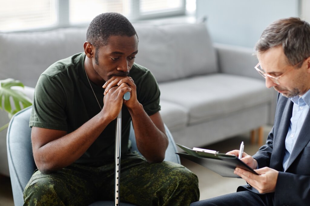 Soldier with baton in hand is in consultation with psychologist
