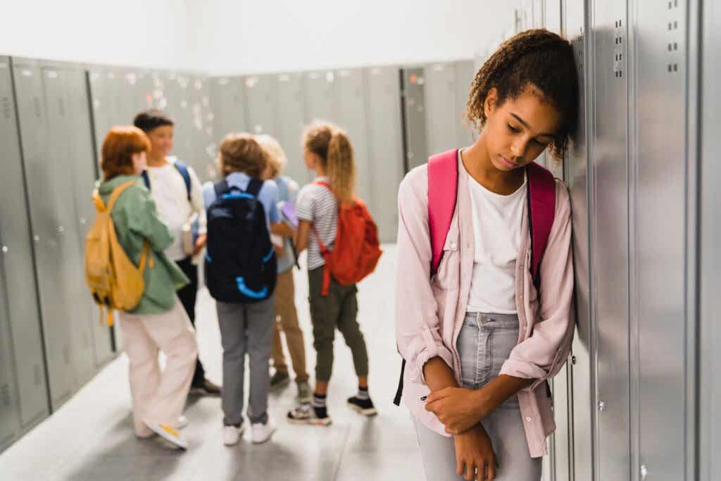 Kids ignore girl who sits alone in school hallway