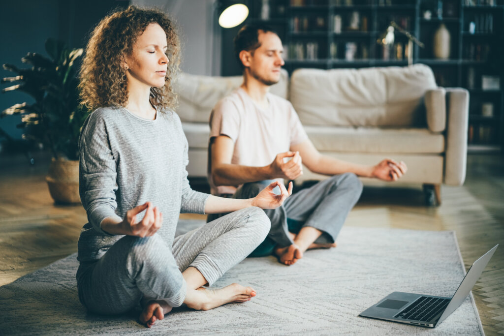 Couple meditates in the living room
