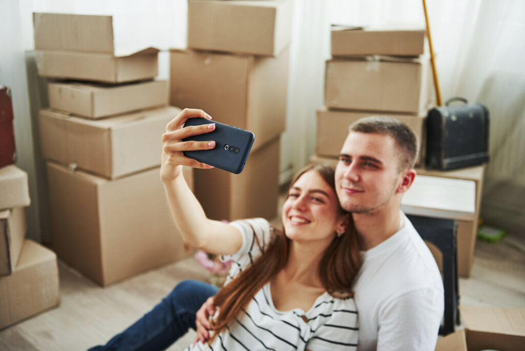 Pareja toma selfie mientras se muda