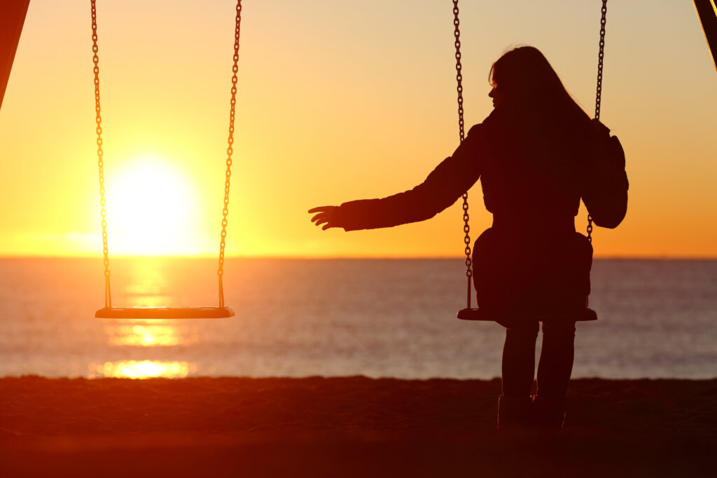 Mulher em balanço durante o pôr do sol