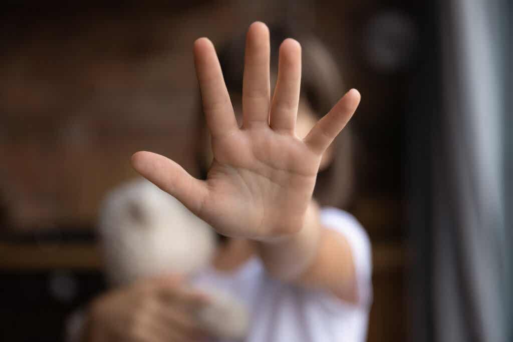 Hand of a child asking to stop child abuse