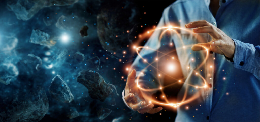 Man hands hold ball of subatomic particles