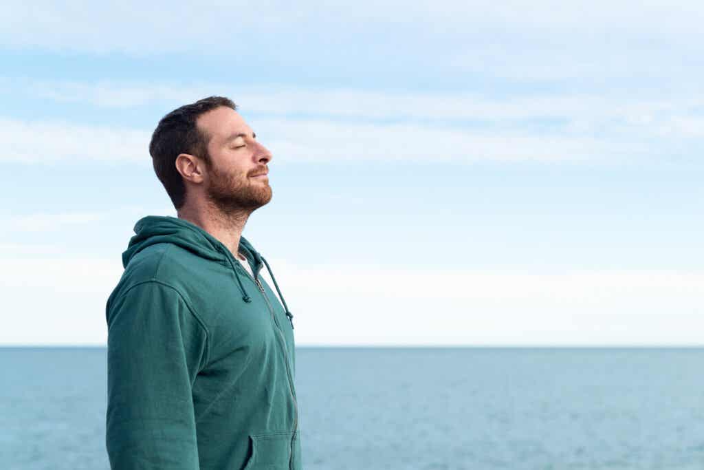 Man practices deep breathing outdoors as part of everyday relaxation